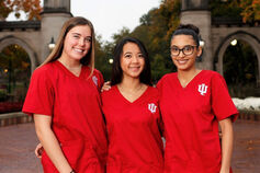 Nursing students in red scrubs